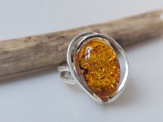 Amber ring. Brown Orange Baltic Amber gemstone ring. Certificated Sterling silver 925 with stamps - hallmarks. Small nice stunning ring. Adjustable size. Very big and stunning amber gemstone ring.  large amber ring weight 8,64 gr small sterling silver 925.  Stone size- 1,6x2,3 cm This item was made of natural Baltic Amber. All the amber used in my jewelry is collected in my home country Lithuania.  I sell only genuine,  real, not pressed, authentic, natural Baltic Amber. Item may have natural im