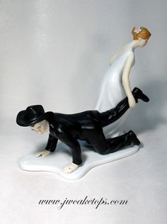 a bride and groom figurine laying on top of each other