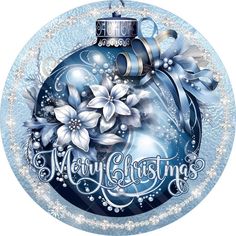 a blue christmas ornament with white flowers and snowflakes on the bottom