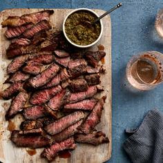 sliced steak on a cutting board with sauce