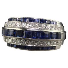 Beautiful Vintage Retro Platinum Old Cut Diamond and Sapphire Cocktail Ring. This gorgeous Retro platinum diamond and sapphire ring is crafted in platinum. The ring features three rows of natural sapphires and two rows of single cut diamonds. The ring is in good condition and appears to have been sized previously. Item #R1972 Metal: Platinum Weight: 11.4 Grams Size: 6 Diamonds: Approximately .40 cts Color: H Clarity: SI1 Sapphires: Approximately 1.50 cts Measurements: Top of the ring measures 11 Diamond And Sapphire Ring, Retro Band, Sapphire Cocktail Ring, Vintage Cocktail Ring, Vintage Cocktail, European Cut Diamonds, Marquise Diamond, Sapphire Stone, Baguette Diamond