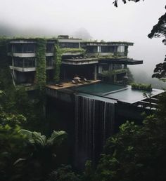 the house is surrounded by greenery and waterfall