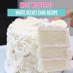 a white velvet cake is being cut with a knife