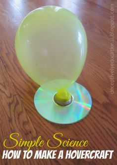 a cd sitting on top of a wooden table next to a glass ball with the words, simple science how to make a hovecraft