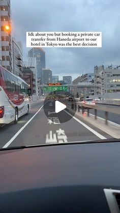 a bus driving down a street next to tall buildings