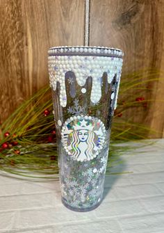 the starbucks cup is decorated with beads and glitters