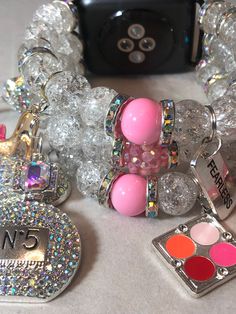 Clear with a splash of pink Apple Watch band ( design available for other smart watches ) charms may vary based on your sentimental values and available charms,. Please include your wrist size. Trendy Pink Charm Bracelets, Adjustable Pink Bracelet With Removable Charms, Adjustable Pink Jewelry With Removable Charms, Trendy Pink Bracelets With Charms, Trendy Pink Jewelry With Bracelet Strap, Pink Bracelet With Removable Charms, Trendy Pink Beaded Bracelets With Charms, Apple Watch Bracelet Band, Pink Apple Watch