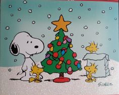 a charlie brown christmas card with a tree and peanuts around it, all dressed up for the holiday season