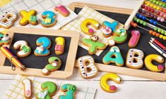 decorated cookies and crayons sit on a table with markers, pencils, and numbers