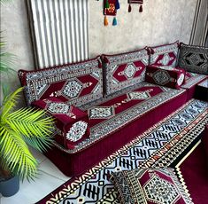 a living room filled with lots of couches and rugs on top of it