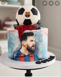 a cake with a soccer ball on top of it and a photo of messi