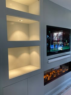 an entertainment center with built - in shelving and fireplace