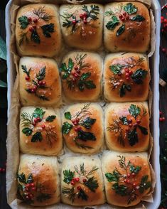 christmas rolls in a baking pan with holly and berries on the top, ready to be baked