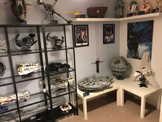 a room filled with star wars memorabilia and legos on shelves next to each other