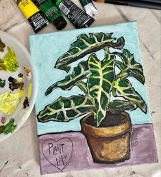 a painting of a potted plant on a table next to some markers and crayons