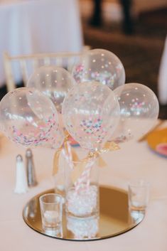 balloons and confetti on a table at a wedding reception