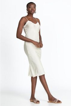 Expertly crafted from 100% silk, the Midi Length Slip is an essential piece with a touch of audacity. The midi length gives this dress an elegant silhouette that is ideal for versatile day-to-evening styling. Layer under a sheer top for additional coverage or wear as a stand-alone slip dress for a luxe going-out look. Women's Midi Length Slip by Johnny Was in Ecru White, Size XS, 100% Silk Feminine Bias-cut Silk Dress, Elegant Beige V-neck Slip Dress, Elegant Silk V-neck Dress For Daywear, Fitted Mid-length Spring Slip Dress, Fitted Mid-length Slip Dress For Spring, Fitted Bias Cut Midi Dress, Spring Silk Knee-length Slip Dress, Chic Sleeveless Dress With Subtle Sheen, Elegant Fitted Viscose Slip Dress