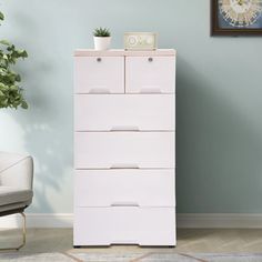 a white chest of drawers in a living room