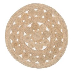 a round rug made out of jute with circles on the center and bottom, in beige