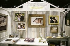 a booth at a wedding show with pictures on the wall