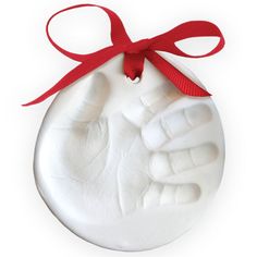 a hand print ornament with a red ribbon around it