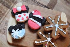 mickey mouse cookies and other treats on a cutting board