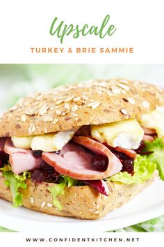 a turkey and brie sandwich with lettuce, cheese, and cranberry sauce