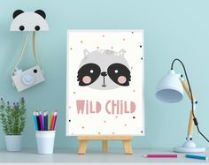 a poster with the words wild child on it next to a lamp and some office supplies