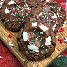 chocolate cookies with white and green sprinkles on a cutting board