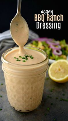 a spoon full of bbq ranch dressing in a jar