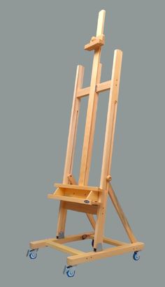 a wooden easel with wheels on a gray background