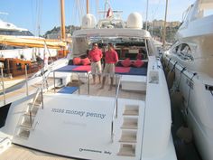 two people standing on the deck of a boat