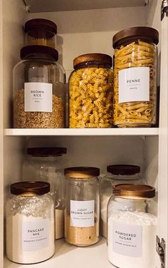 some jars filled with pasta and other food items