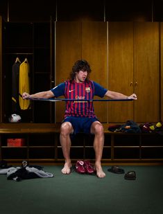 a man sitting on top of a bench holding a bar