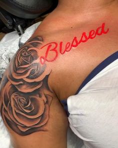 a woman with a rose tattoo on her shoulder that says, bessed written in red ink