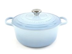 a blue casserole with a lid on a white background