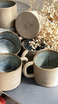 four coffee cups sitting on top of a table