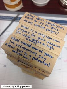 several pieces of wood with writing on them sitting on top of a table next to cups