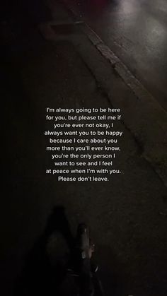 the person is walking down the street at night