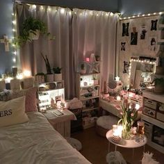 a bedroom decorated in white with lots of lights