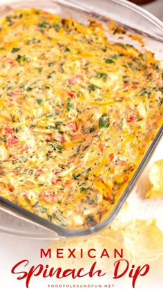 mexican spinach dip in a casserole dish with tortilla chips on the side