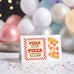 a card with a slice of pizza on it sitting next to balloons and confetti