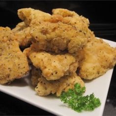 some fried food on a white plate with parsley