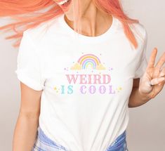 Weird is cool.  * Q U I C K * F A C T S * ⭑ Premium quality fabric cotton ⭑ Thick - soft - comfy ⭑ Design is high quality digitally printed ⭑ Wash cold, inside out, air dry is best but regular wash/dry is fine as well * S I Z I N G * ⭑ Sizing is unisex: not skin tight and not overly large. ⭑ Most people find their typical size works best unless desiring an oversized look ⭑ See the size guide in listing photos to determine most accurate fit. * S H I P P I N G * T I M E S * ⭑ Our items are individ Pride Funny Print Cotton Top, Funny Print Cotton Top For Pride, Retro Rainbow Cotton Tops, Fun Cotton Tops For Pride, Retro Cotton Tops For Pride, Goth Clowncore, Kitsch Clothing, Weirdcore Outfits, Kidcore Clothing