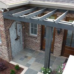 an outdoor shower in front of a brick building