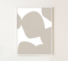 a white and gray abstract art piece hanging on a wall