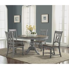 a dining room table with four chairs around it