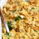 a casserole dish with broccoli, cheese and bread crumbs