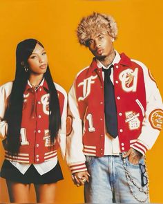 two people standing next to each other wearing red and white jackets with letters on them