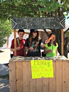 three people stand behind a sign that says porridges and have a nice day